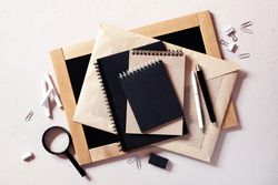 Top view of variety of tan and dark office supplies