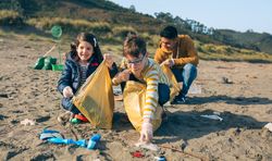 Young volunteers cleaning the beach