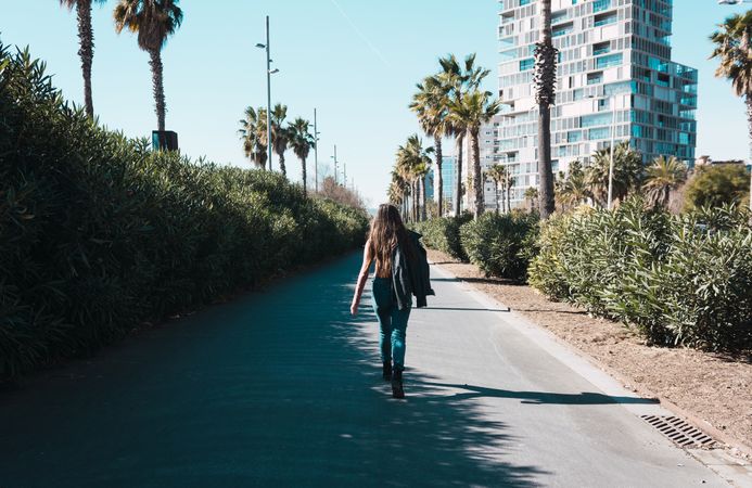 Teen girl walking happily through the streets.