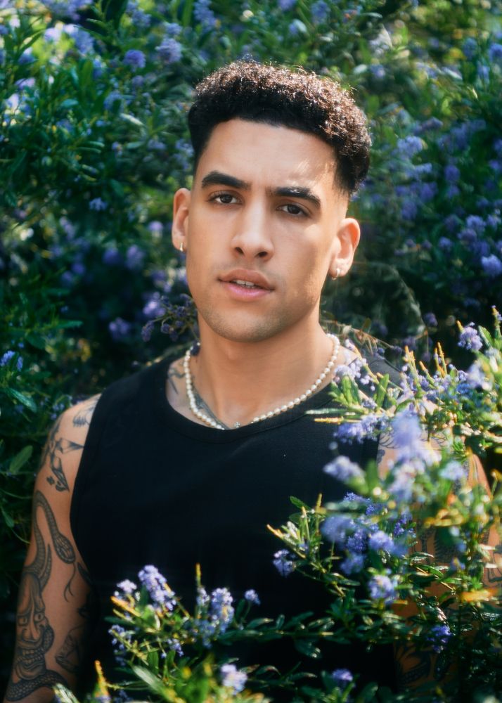 Portrait of tattooed male model in garden