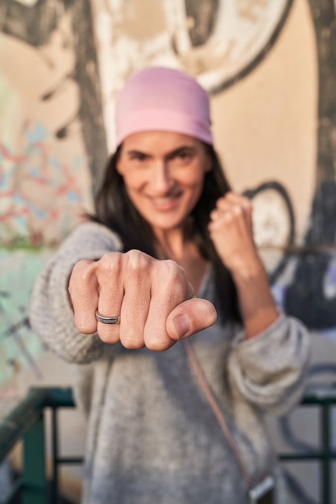 Smiling female in bandana hitting camera and smiling