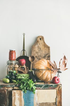 Fresh autumnal vegetables on kitchen counter, with squash, cabbage, relish, peppers, copy space