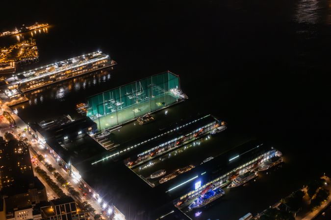Aerial View with Private Docks with Luxury Boats and Yachts. Panorama of the Area from a Helicopter, Showing Residential and Industrial Buildings. Harbour Area with Ship and Loading Equipment