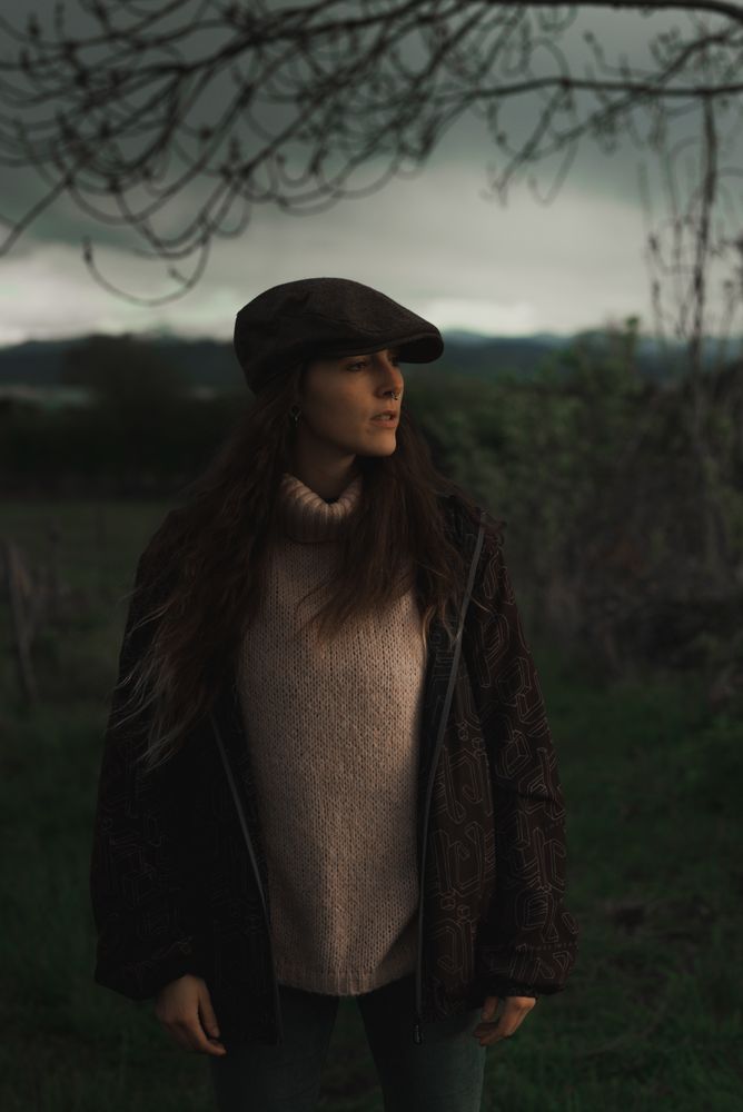 Young woman in warm clothes in forest