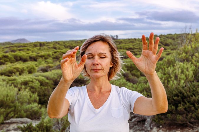 Adult woman practicing martial arts in nature