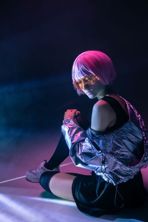 Woman sitting in sparkly silver jacket