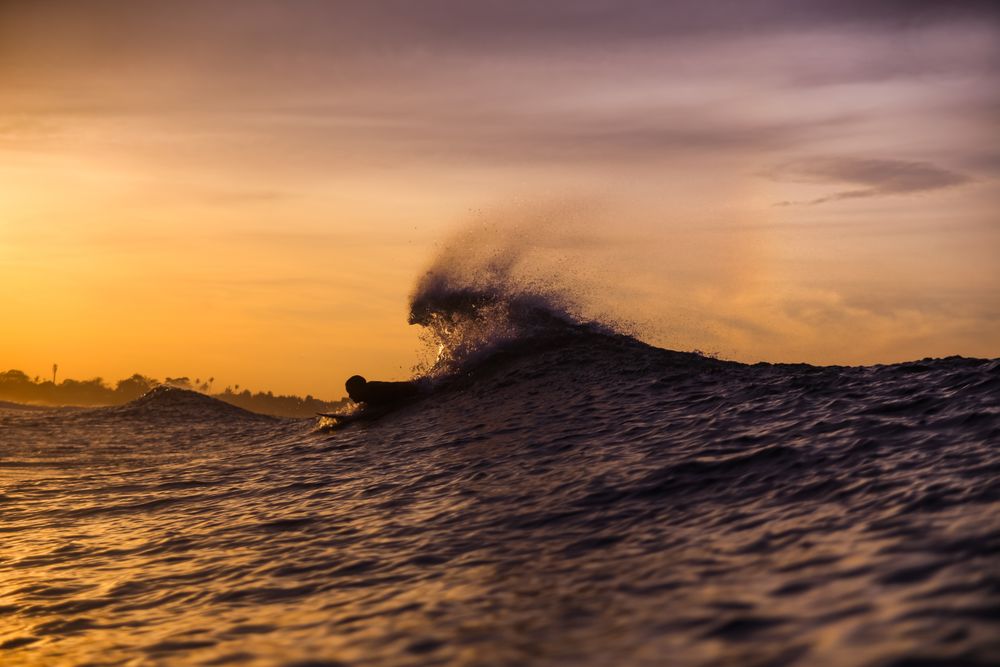 Man on surf board floating on wavy water