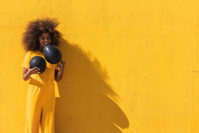 Black girl holding party balloon