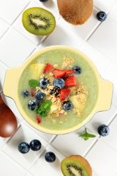 Top view of smoothie with fresh fruit and granola