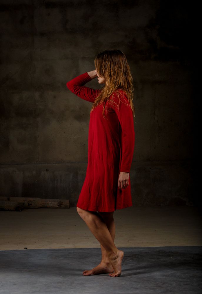 Young woman dancing in darkness
