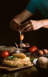 Crop man breaking egg near pie