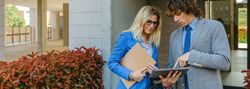 Businesspeople checking documents in the street