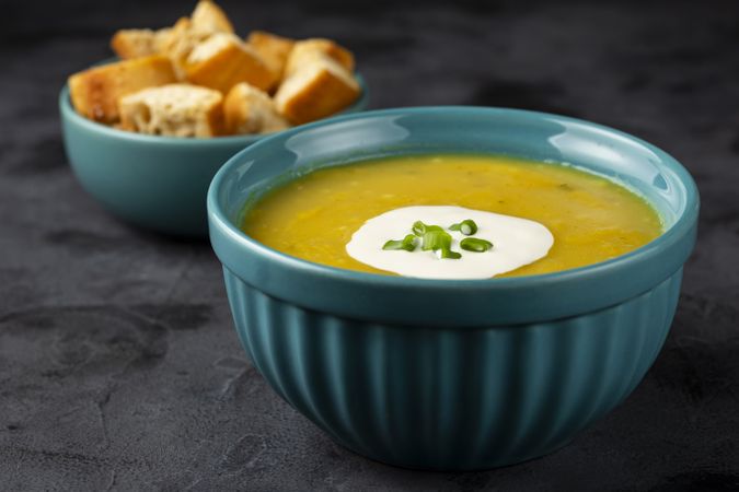 Bowl with pumpkin soup on the table.