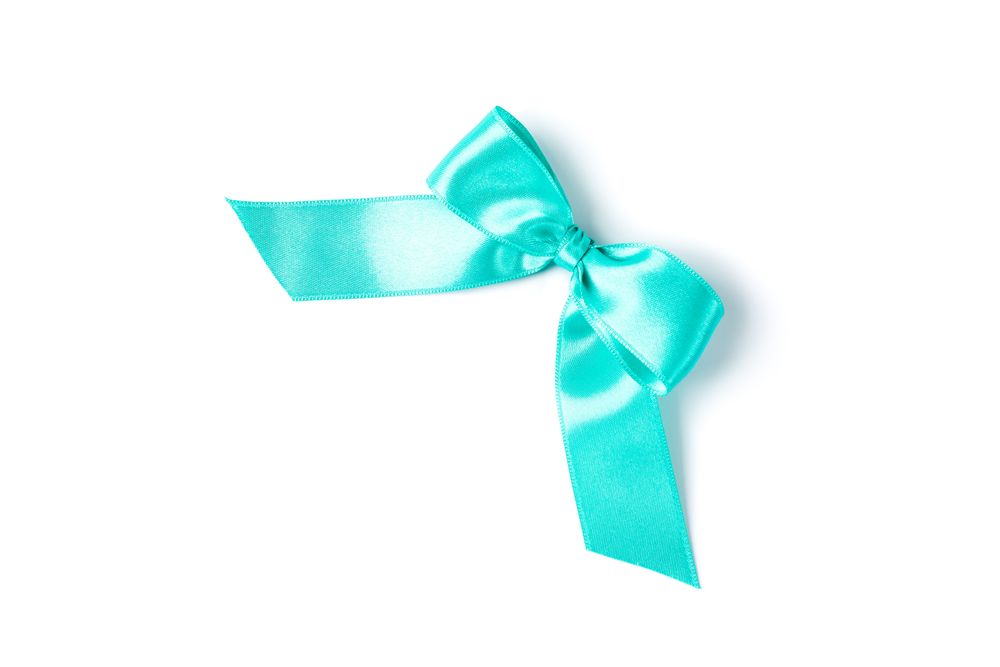 Turquoise bow isolated on plain background. Gift concept
