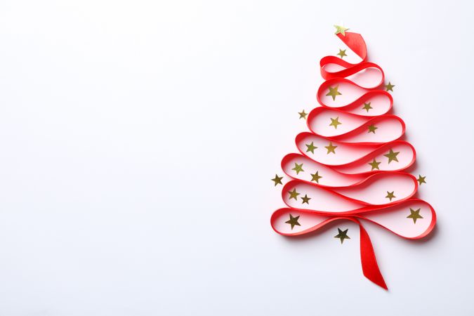 Christmas tree made from red ribbon and glitter on light background, space for text