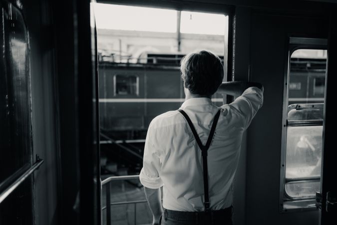 Traveler looking out train window