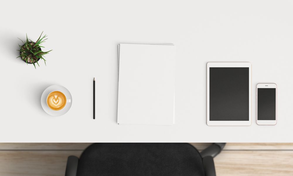 Modern workplace with coffee cup and smartphone or laptop copy space on table background. Top view. Flat lay style.