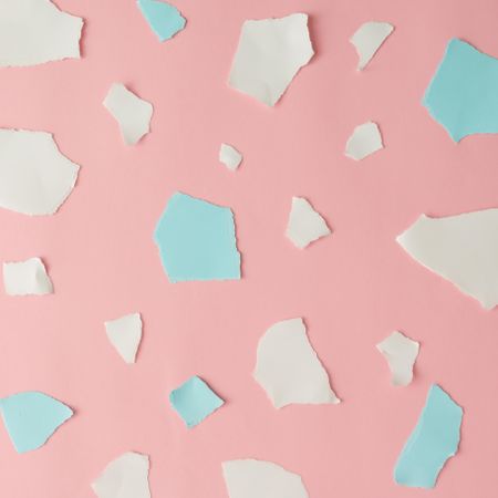 Pieces of ripped pastel colored paper in pattern