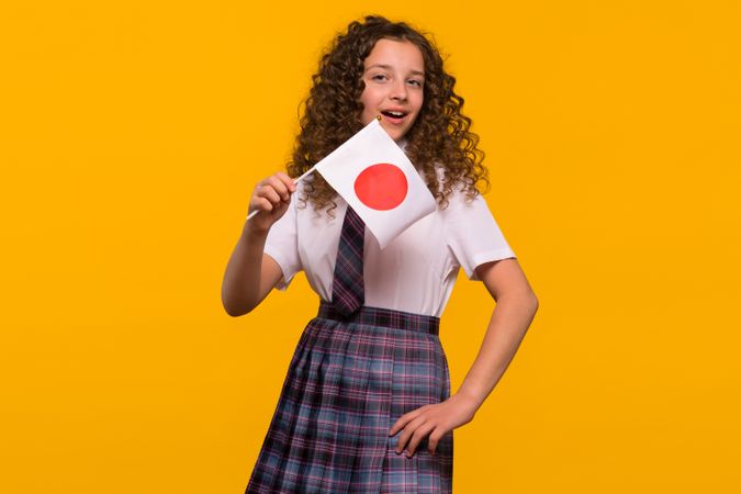 Cheerful girl holding Japanese flag