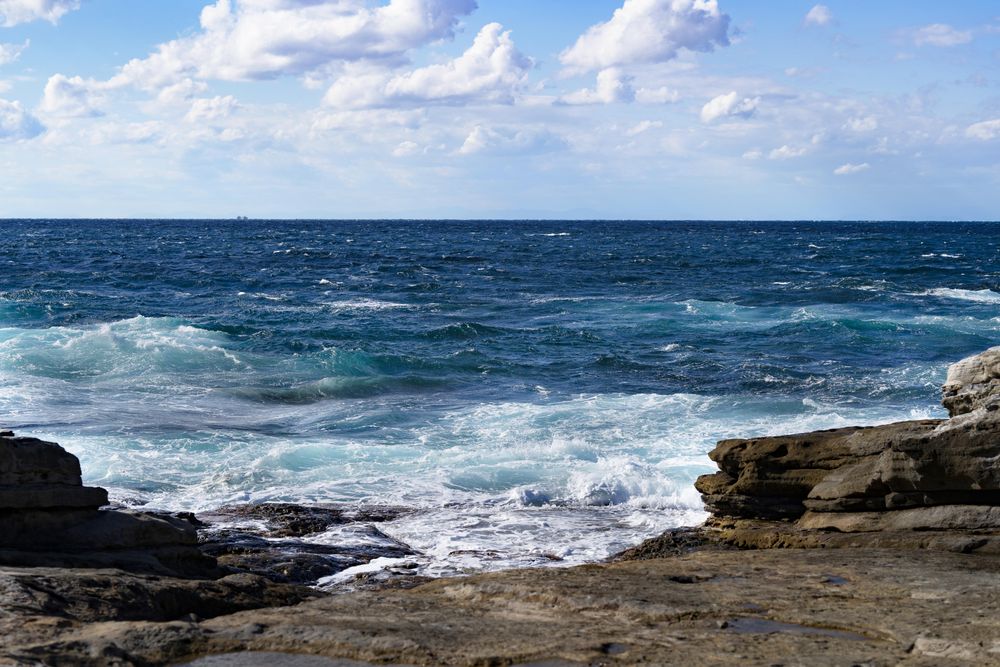 Waves coming in from the ocean onto rocky shore