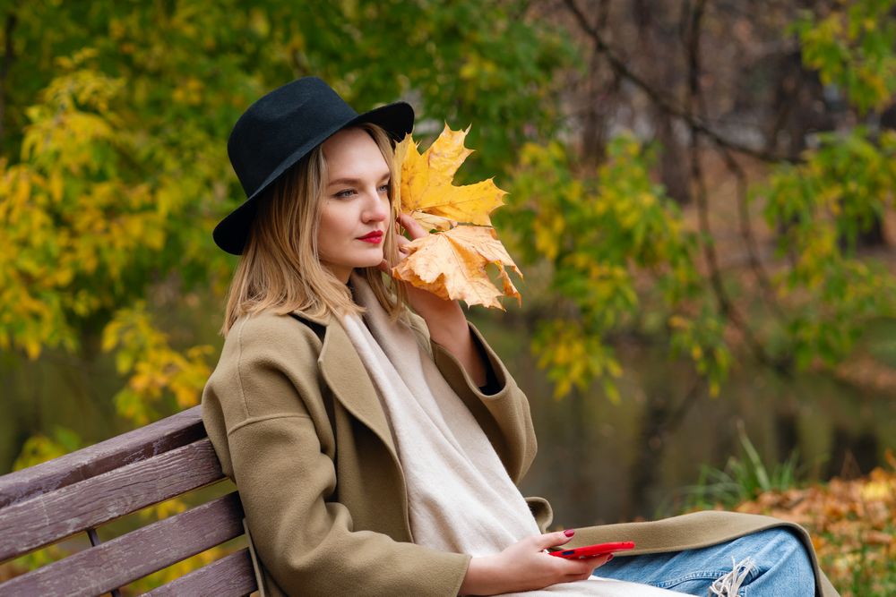 Woman on park bench in autumn
