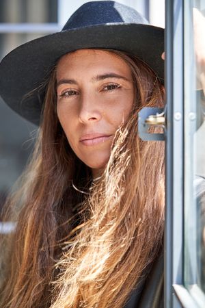 Young woman in hat with long hair