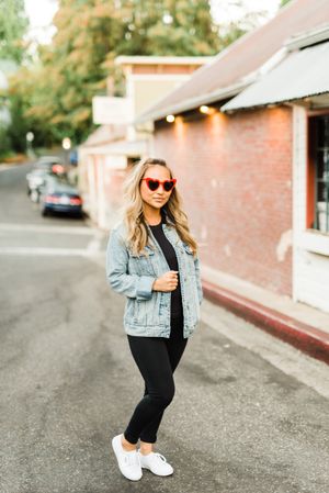 Woman with sunglasses standing on road
