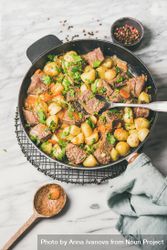 Braised beef stew with potatoes, carrots and parsley, with wooden spoon 42nQy4