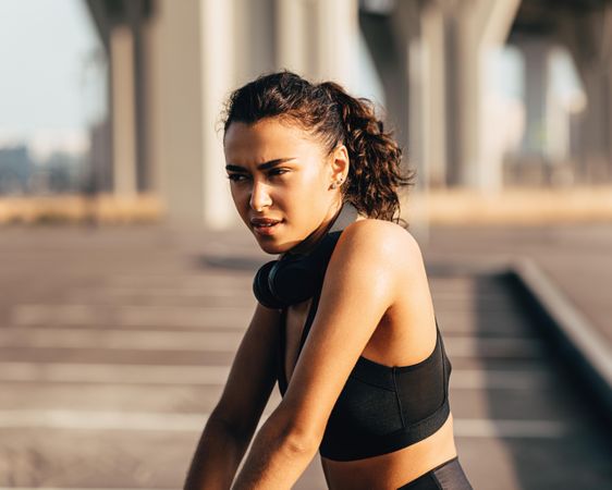 Fit woman with serious expression in the late afternoon sun