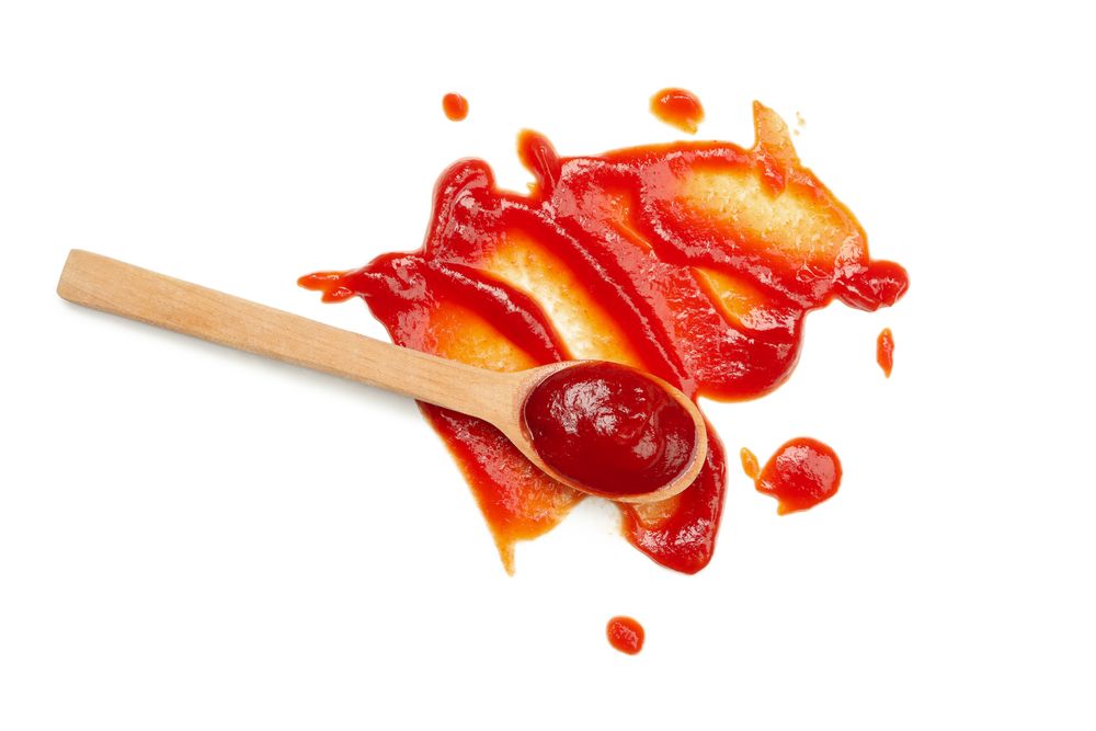 Wooden spoon and sauce isolated on blank background