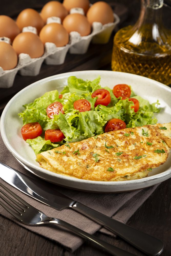 Omelet with cheese and lettuce and tomato salad.