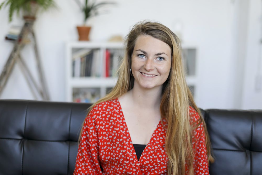 Portrait of happy young woman sitting on sofa