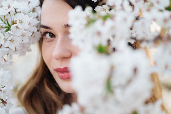 woman amidst white flowers