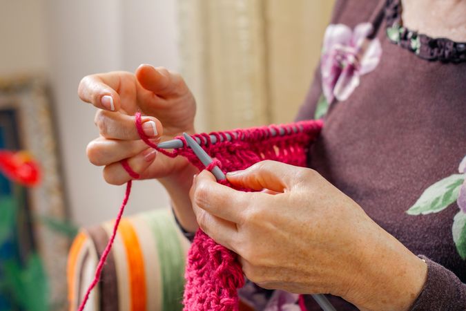 Hands of woman knitting a wool sweater