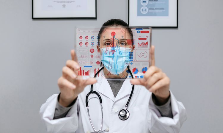 Female doctor looking at transparent tablet with medical digital diagnostic screen