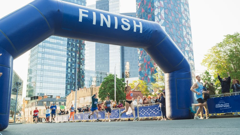 Wide Shot of a Diverse Group of Runners Participating in a City Marathon