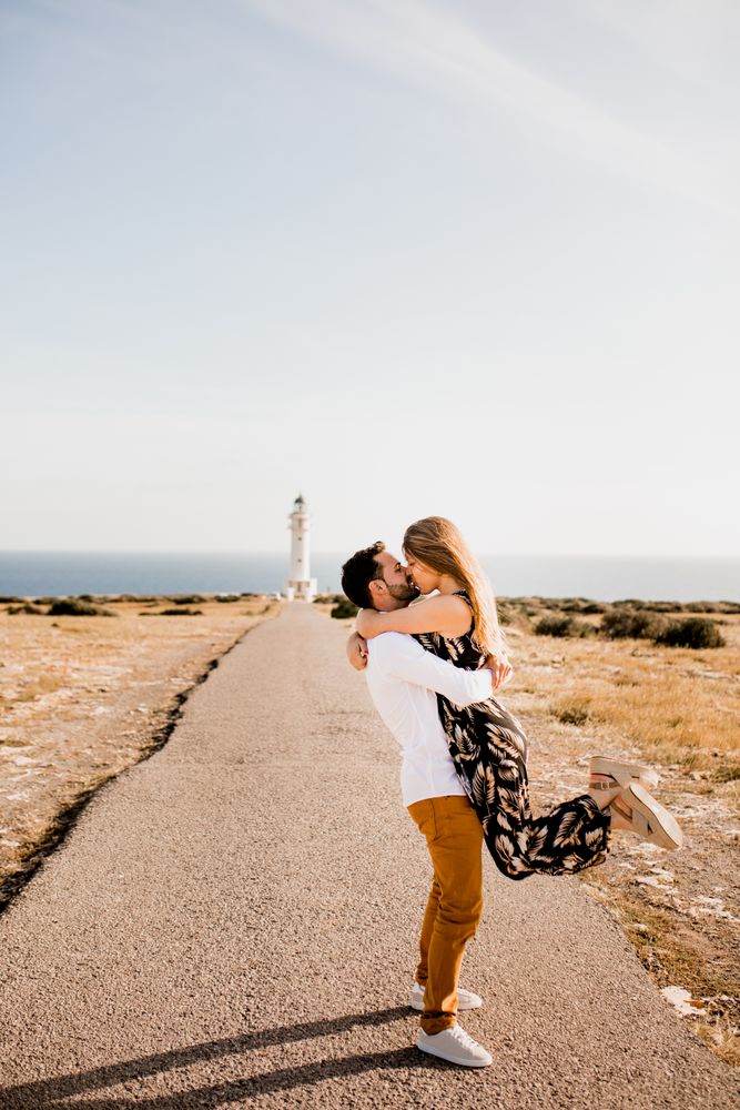 Happy lovers having fun on path from sea