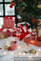 Gift boxes and ornaments under Christmas tree indoor 0VydXb