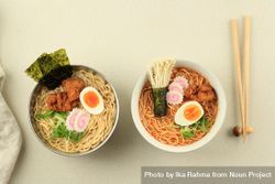 Two bowls of ramen with karaage chicken and egg toppings 4AkxW0
