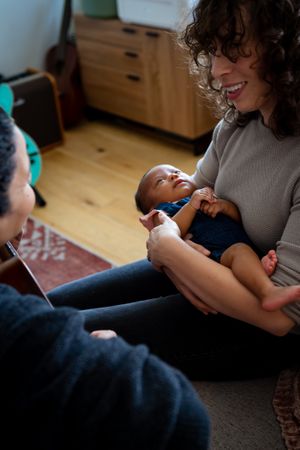 Mother holding baby looking at partner