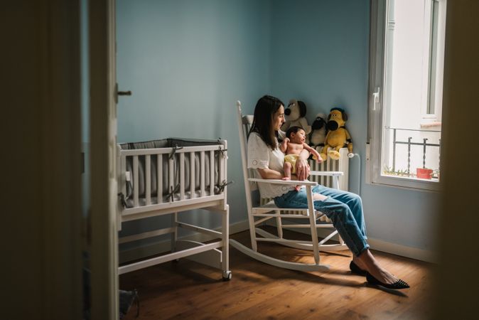 Mother with baby in nursery