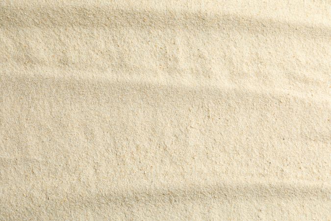 Clear sea sand as background, space for text and closeup. Summer vacation background