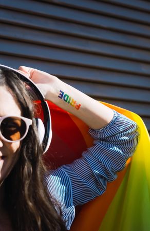 Woman posing happily with the LGBT flag