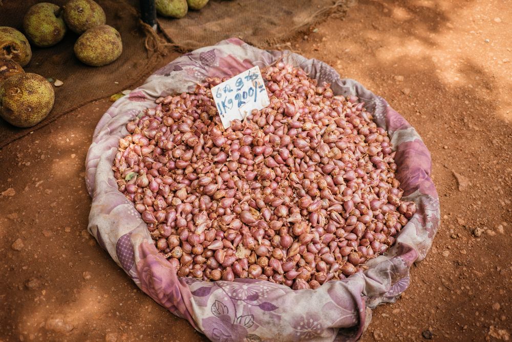Basket of shallots lined with scarf for sale at Sri Lankan market