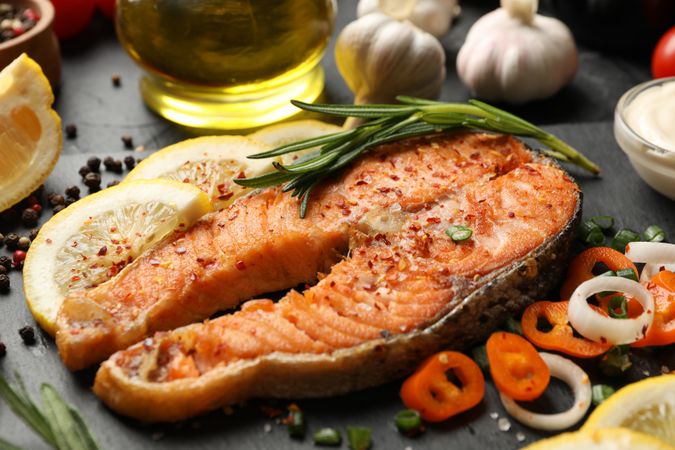 Composition with tasty grilled salmon on dark background, close up