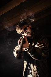 Man with shotgun and cigarette