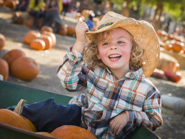 Little Boy in Cowboy Hat at Pumpkin Patch