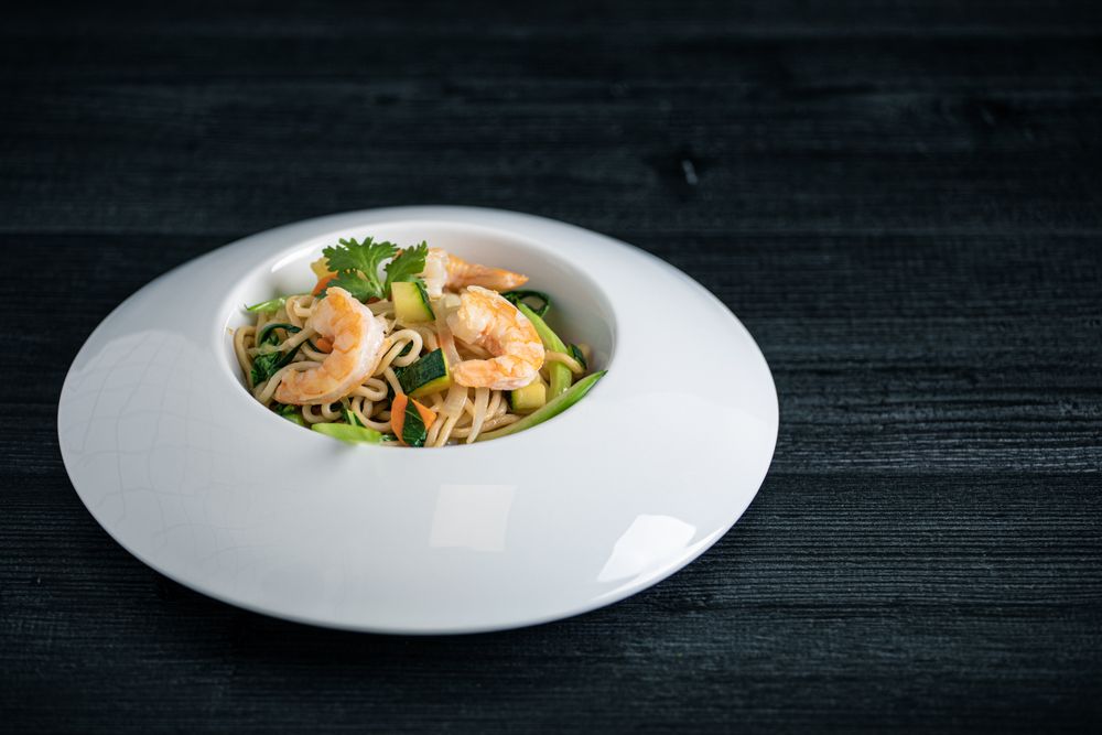 Tasty Pad Thai of vegetables and prawns in plate