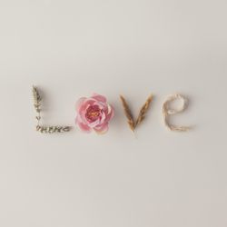 Word LOVE made out of flowers and dried branches