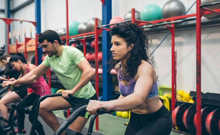Athletes doing air bike indoor
